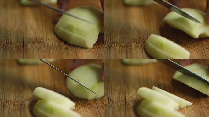 在砧板上把去皮的苹果切成薄片