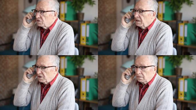 微笑的老人在电话里谈笑风生