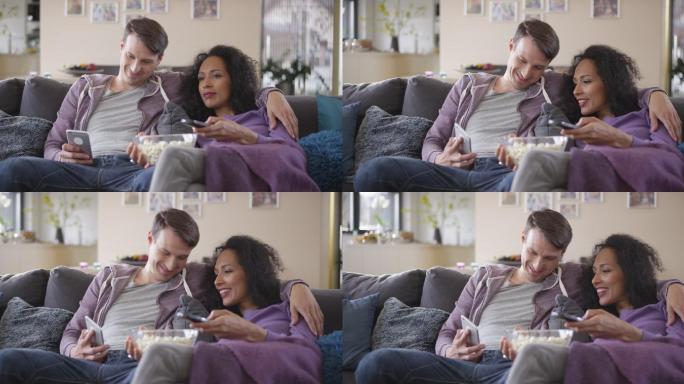 DS男子一边和女友看电视一边玩手机