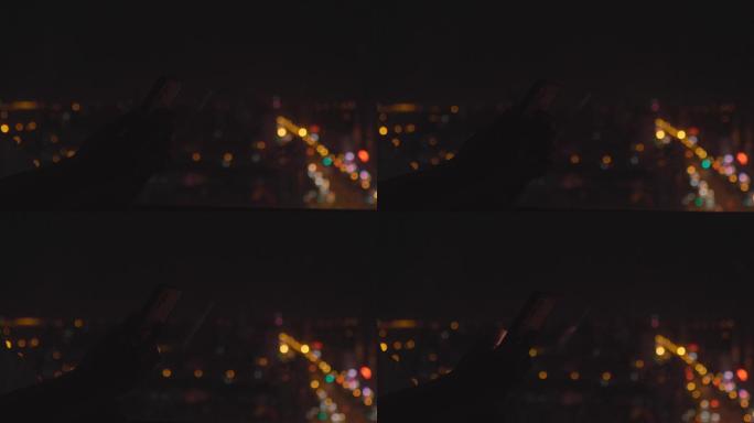 4K夜晚窗边看手机城市夜景