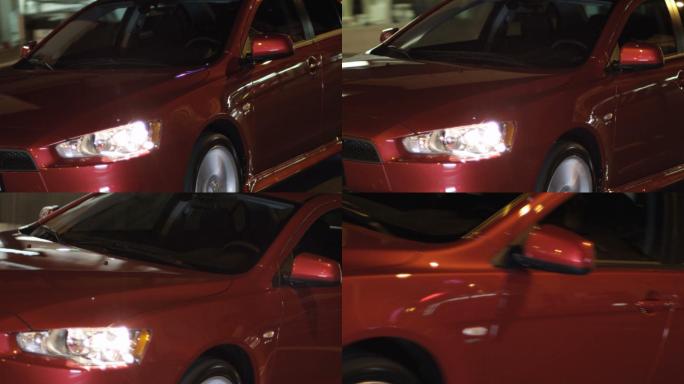 一辆红色汽车在夜间行驶的动态照片。