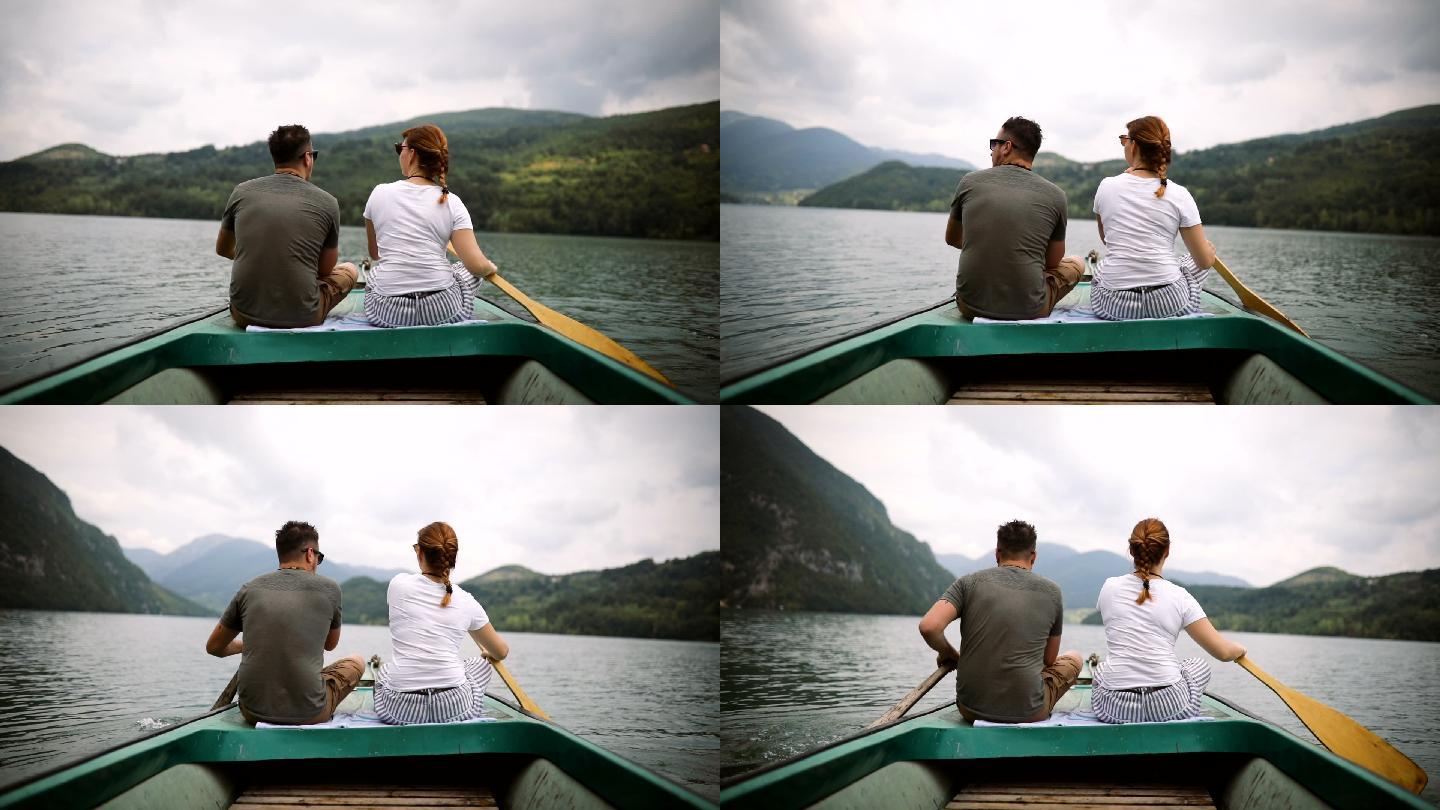 年轻夫妇在湖边的船上共度时光
