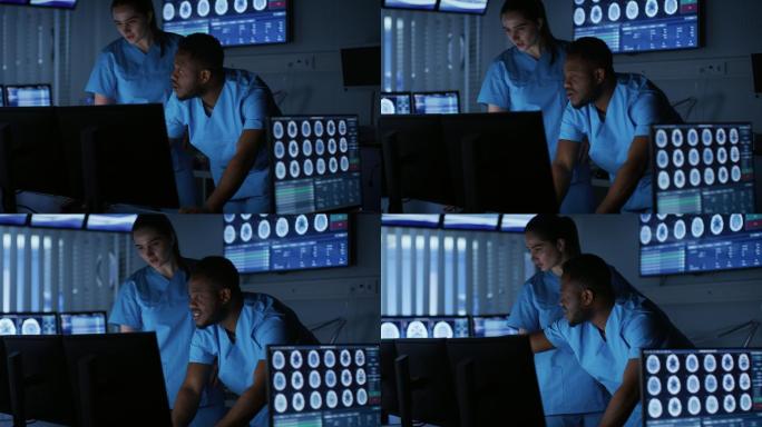 两位神经学家在实验室里用电脑交谈工作