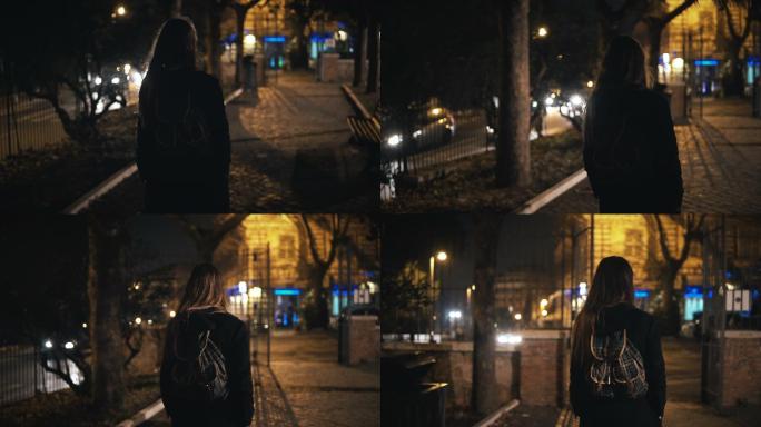 背着背包的女人独自一人深夜散步
