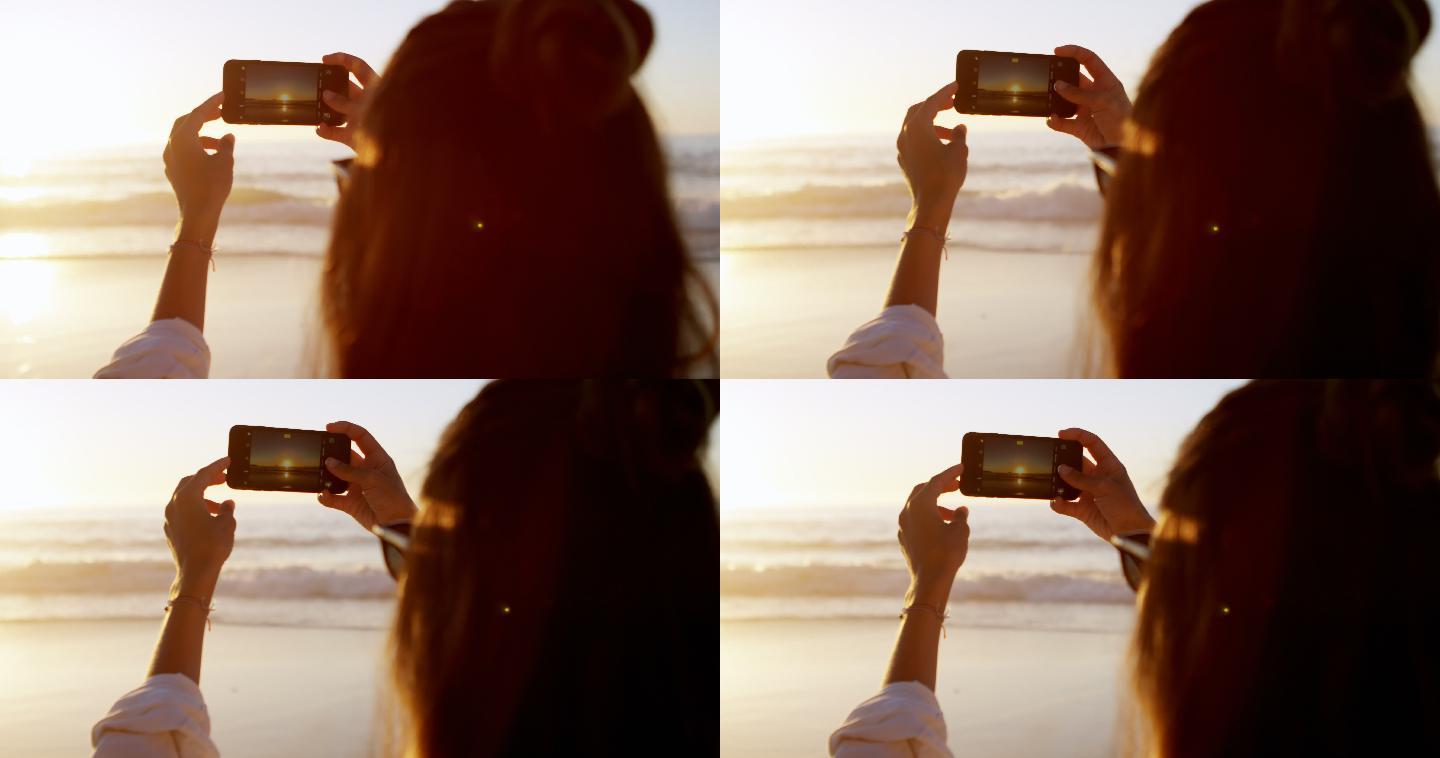 在海滩用手机拍照的女人