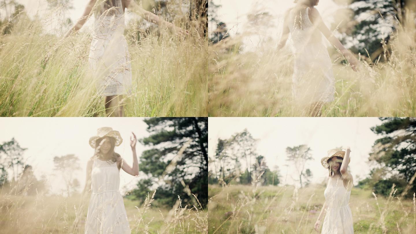 草地上的女人草丛白纱裙张开手臂