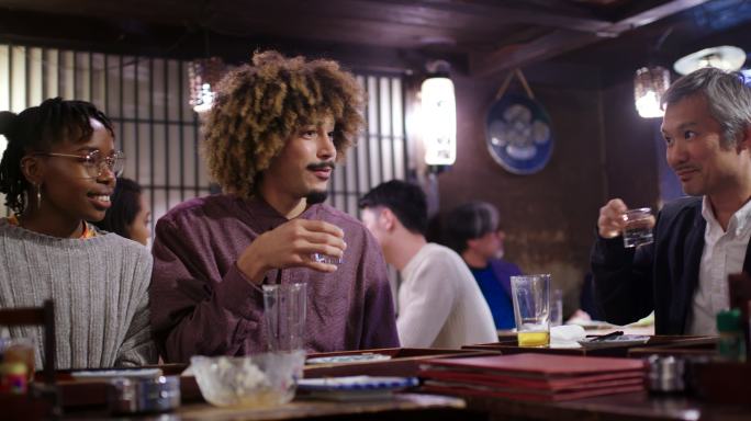 游客在传统的日本青冈和当地人喝清酒