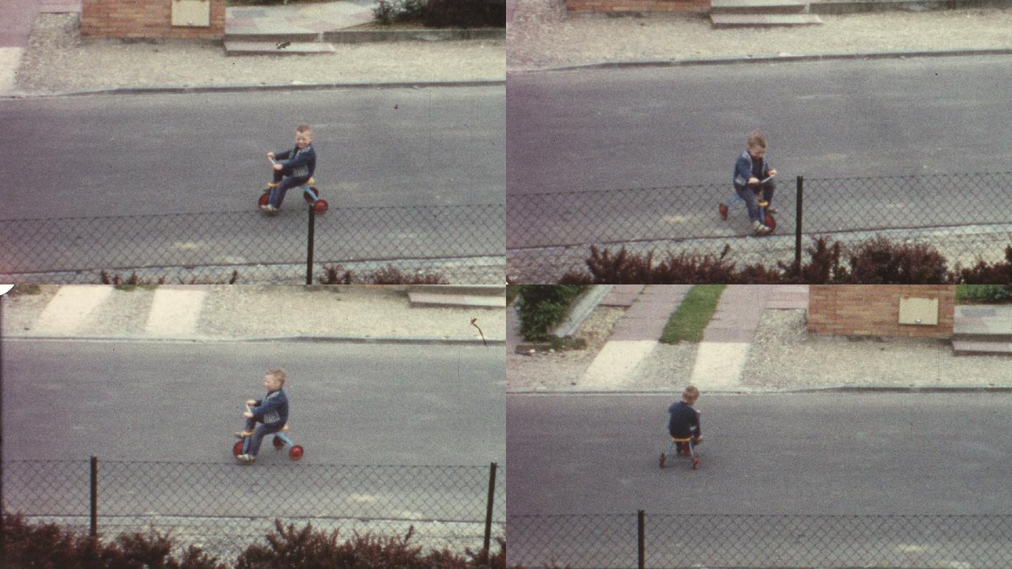 小男孩在街上骑三轮车