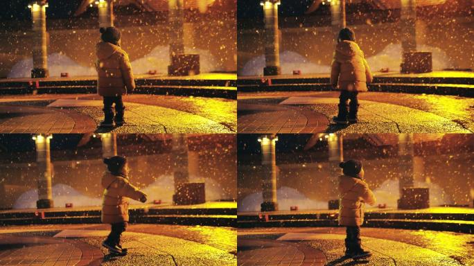 可爱的小男孩在夜晚无忧无虑的玩雪