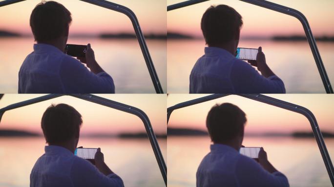 湖面上浪漫的日落年轻人在船上拍照