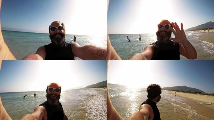 在海边拍摄视频的男人