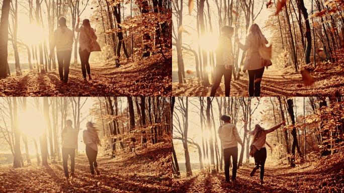 一对年轻夫妇在森林里抛树叶
