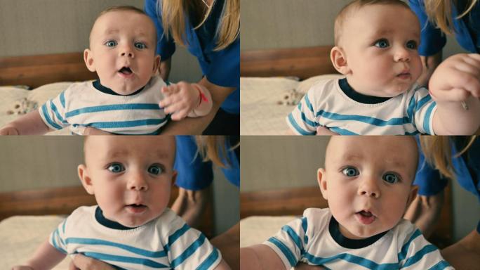 可爱的蓝眼睛婴儿惊奇地看着镜头