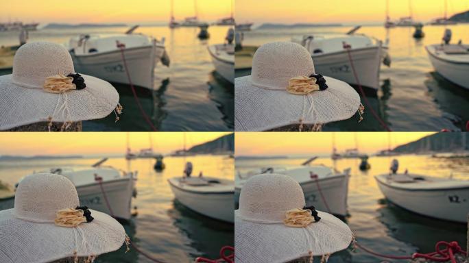 日落时码头上的一顶帽子