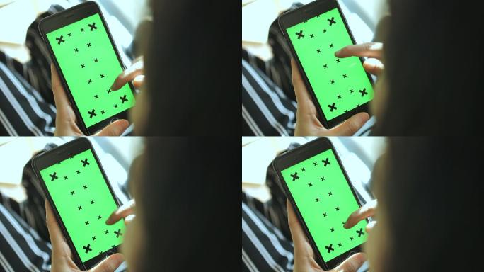 使用绿屏智能手机的女人