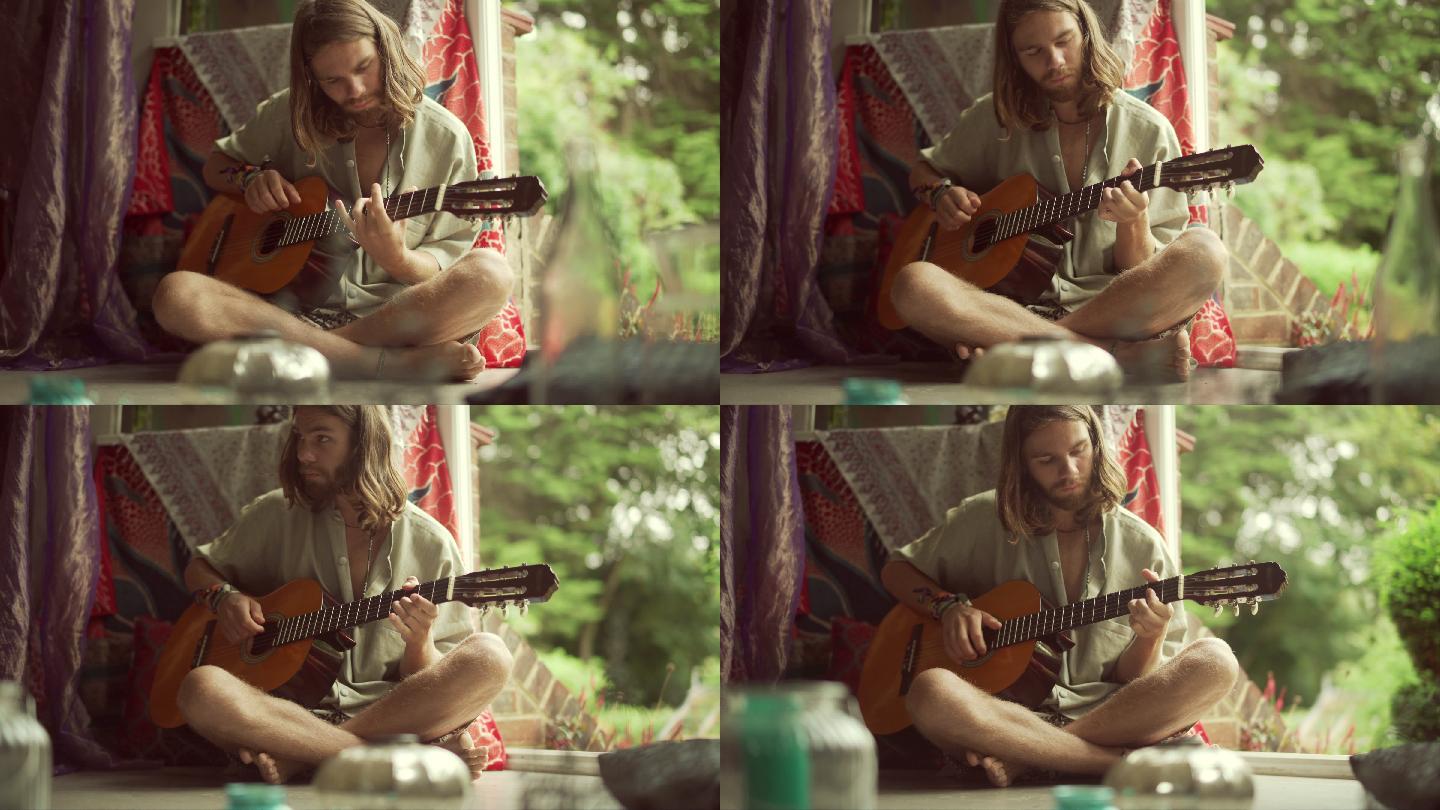 一个长发男人在弹吉他