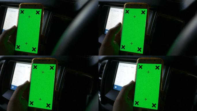 司机在车内使用绿色屏幕手机导航