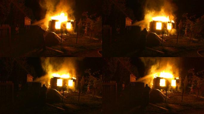 村里的木屋在夜间燃烧着火焰