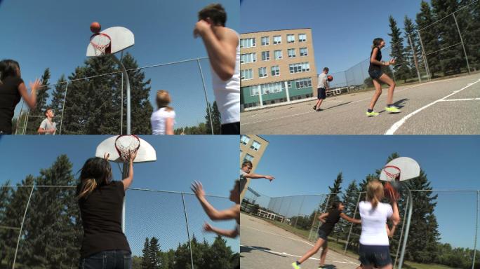 一群青少年在篮球场上打篮球。
