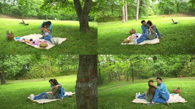 快乐的男人在公园野餐时给女友惊喜。