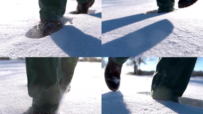 雪山上行走的人的脚的特写镜头。