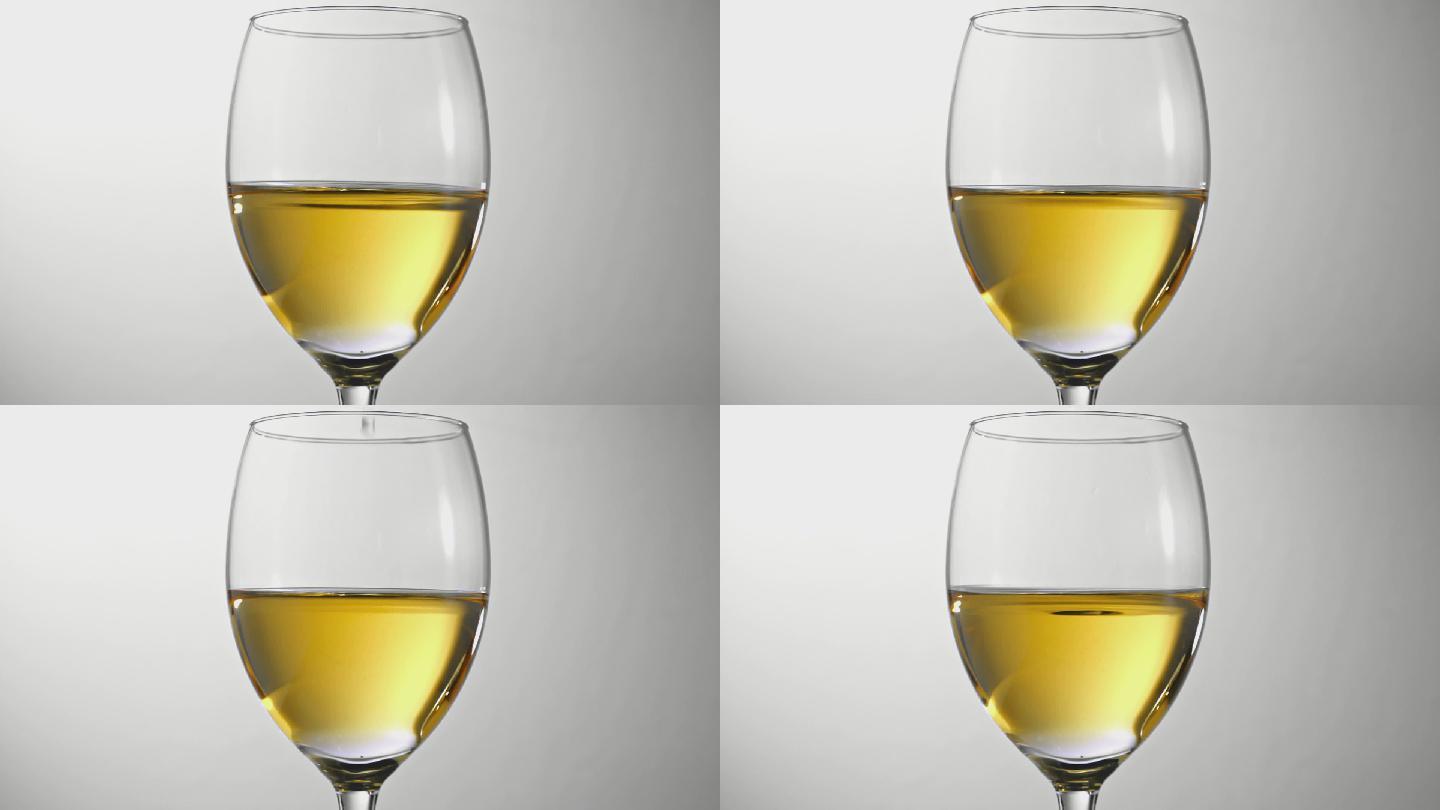 一滴白葡萄酒倒酒金色质感高脚杯