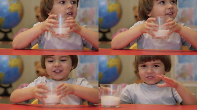 小男孩微笑着，早餐喝牛奶。