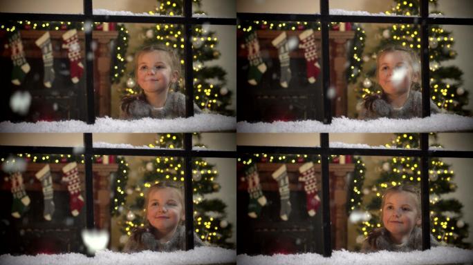 圣诞节时，小女孩凝视着窗外飘落的雪