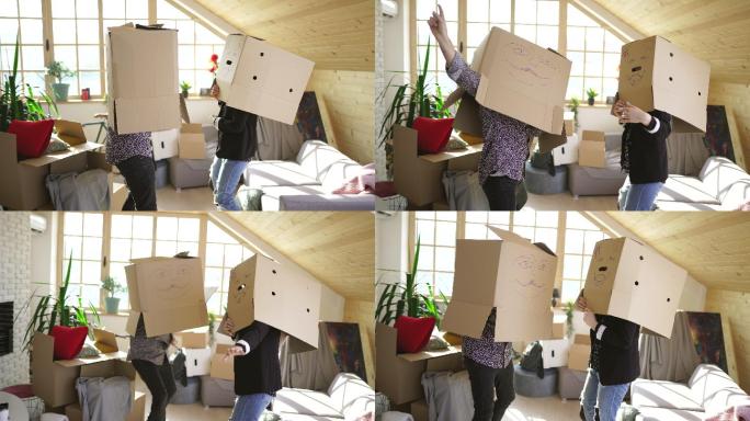 一对夫妇在新公寓里玩纸板箱