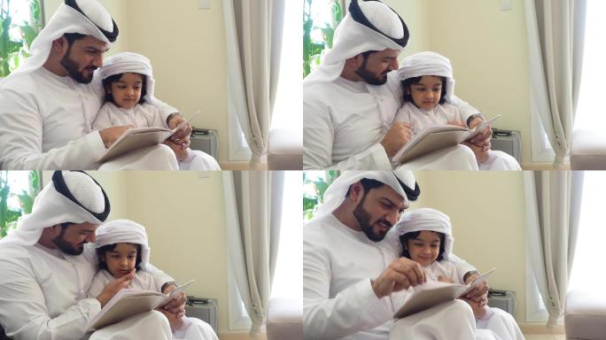 阿拉伯父子在家看书做作业