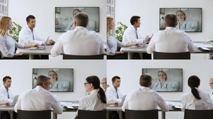 一组医生与一位女同事进行视频电话会议