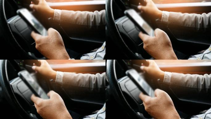 男司机在车内使用智能手机