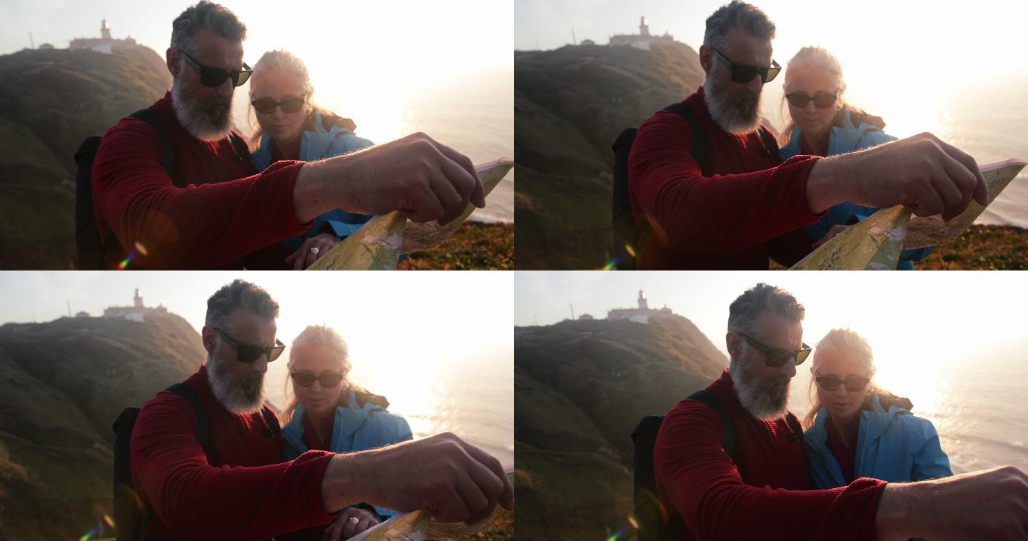 老年夫妇在海边悬崖上查看地图的特写镜头