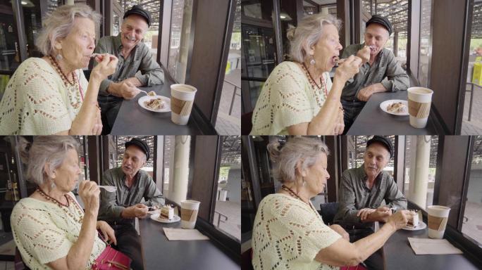 快乐的老年夫妇享受咖啡和蛋糕