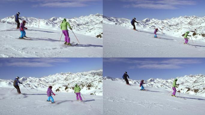 爸爸妈妈教他们的女儿滑雪