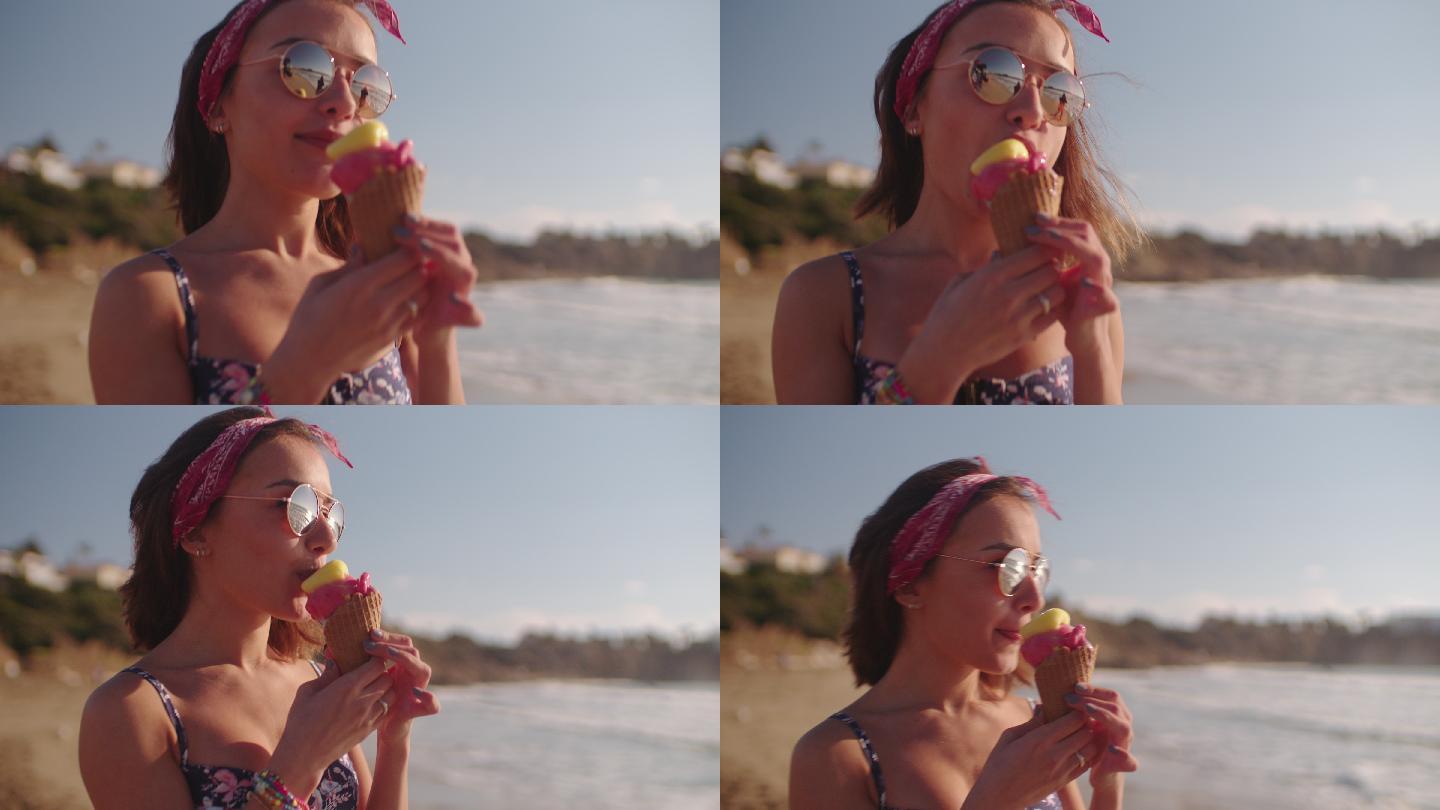 年轻的时髦女人吃冰淇淋在海滩散步