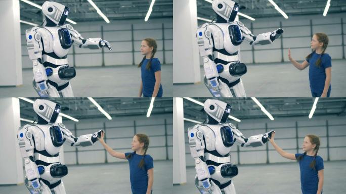 机器人正在给一个小女孩击掌