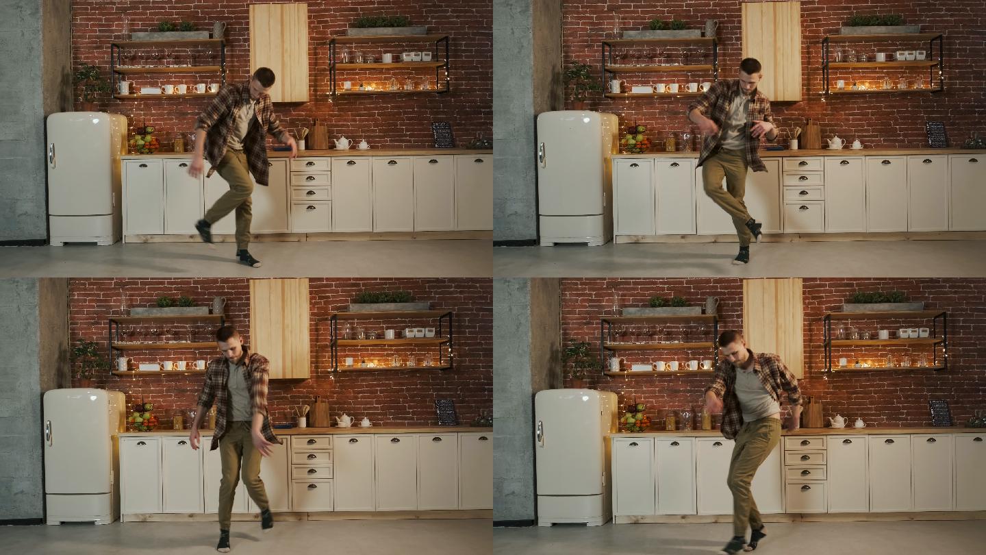快乐的年轻人在厨房里跳舞。