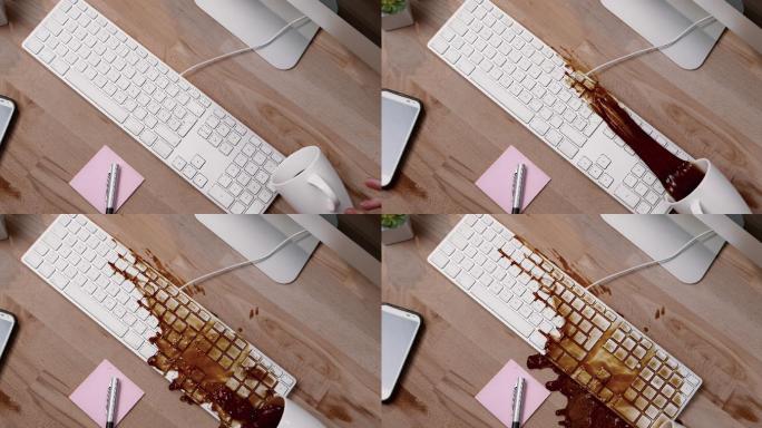 一杯咖啡洒在办公桌上的白色电脑键盘上