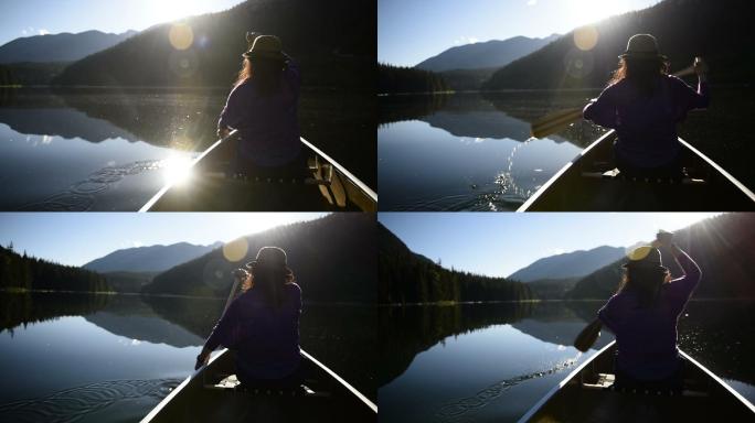 在原始的湖面上划独木舟的女人