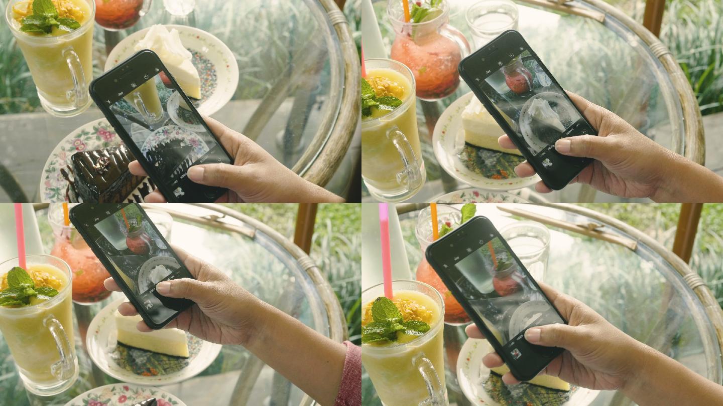 女性用智能手机拍摄食物