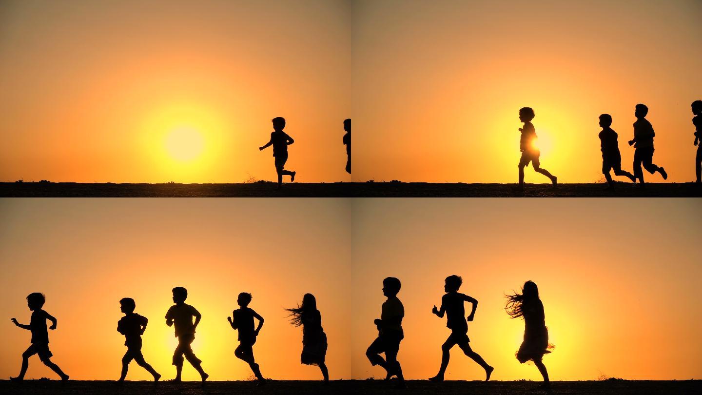 五个孩子在夕阳下奔跑的剪影