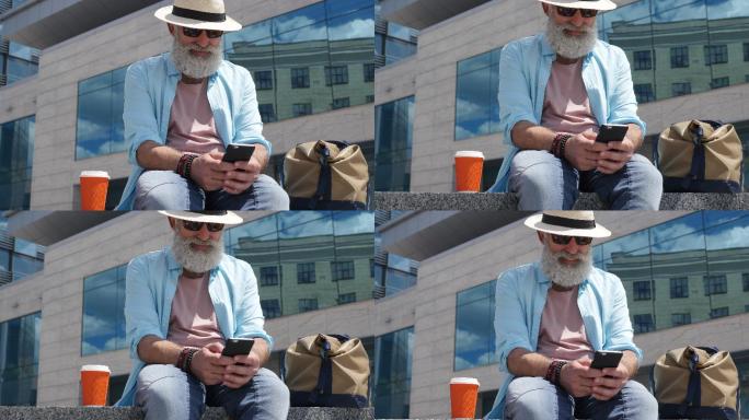 老人在坐在城市街头使用手机