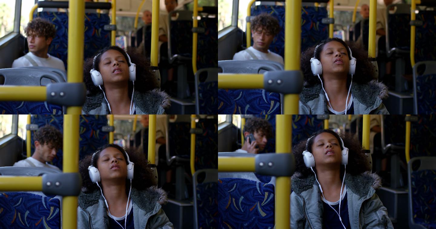 坐公交车时戴着耳机听音乐的女孩