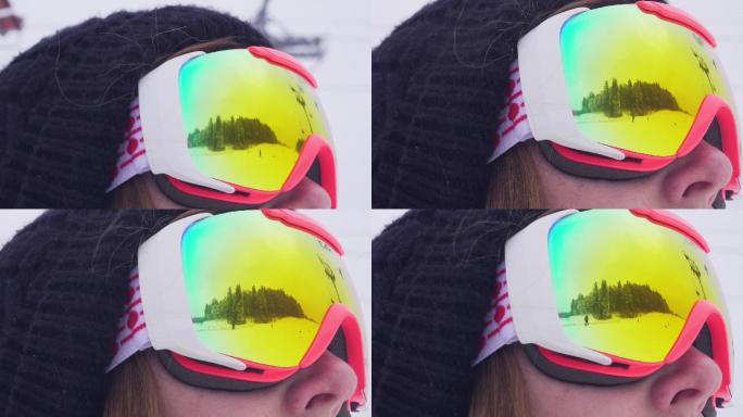 通过眼镜反射看到一个滑雪运动员在滑雪