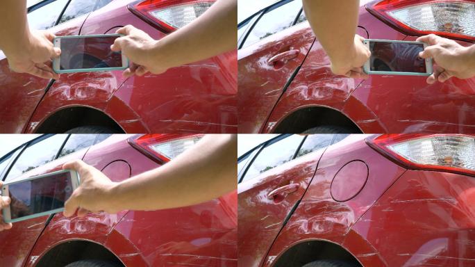 特写用手机在汽车漆皮划伤处拍照。
