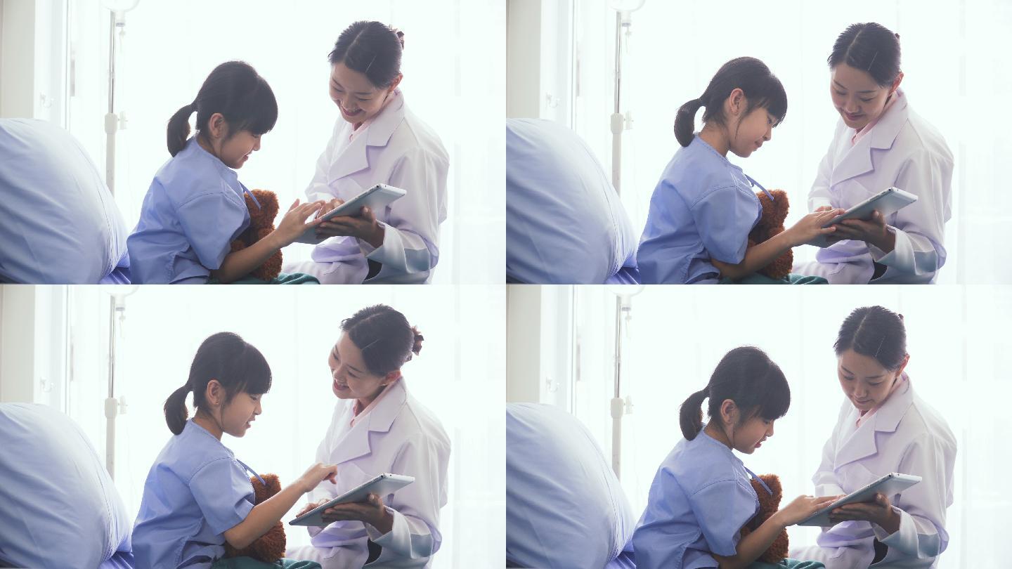 医院病房里医生与女孩在玩数字平板电脑