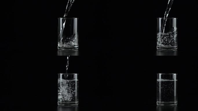 慢动作：把水倒进黑色背景的杯子里。