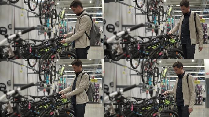 一个男人子在体育器材商店比较自行车