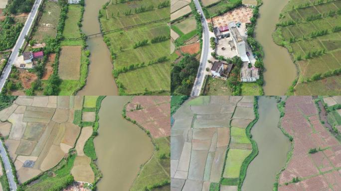 俯拍一条小溪流经过农田和村庄